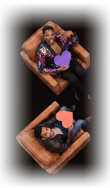 Two daters seated in leather armchairs holding paper hearts