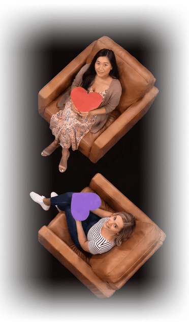 Two more daters seated in leather armchairs holding paper hearts
